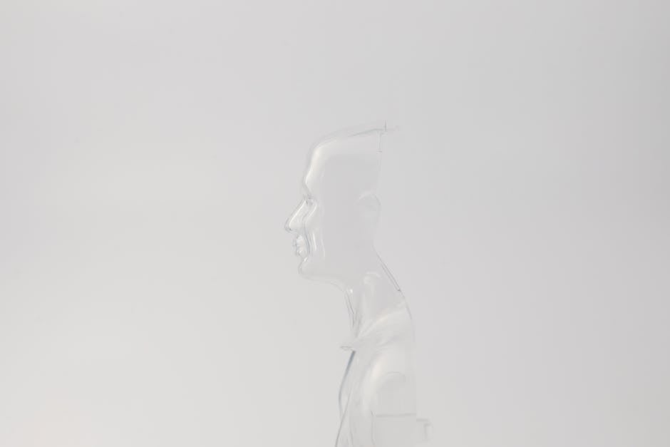 Abstract transparent human figure profile on a soft white background.