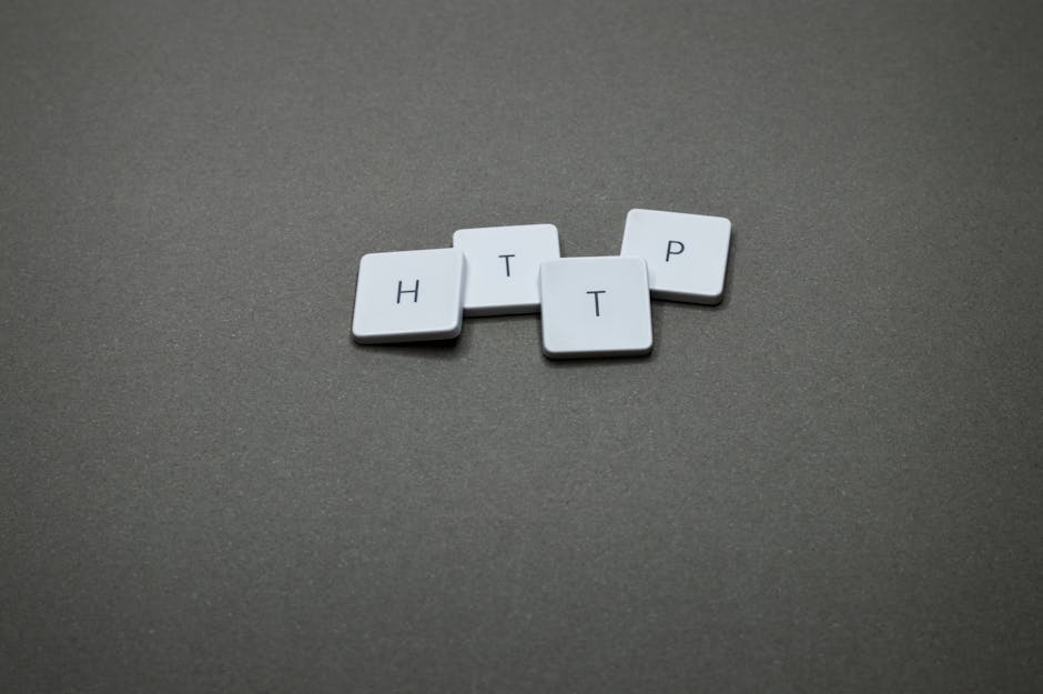 High-angle photo of keyboard tiles spelling HTTP on a dark background.