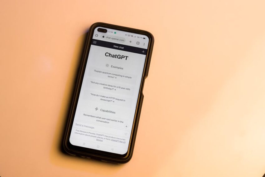 Smartphone showing ChatGPT website with warm tone, highlighting AI technology.