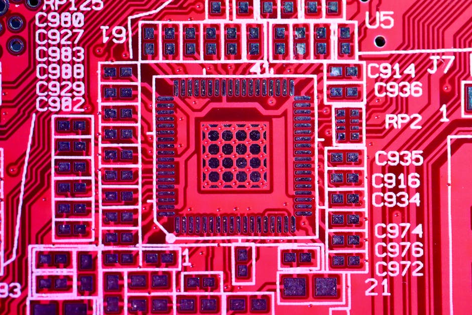 Top view of contemporary bright red printed board with electric circuits and various numbers with letters of modern electronic device
