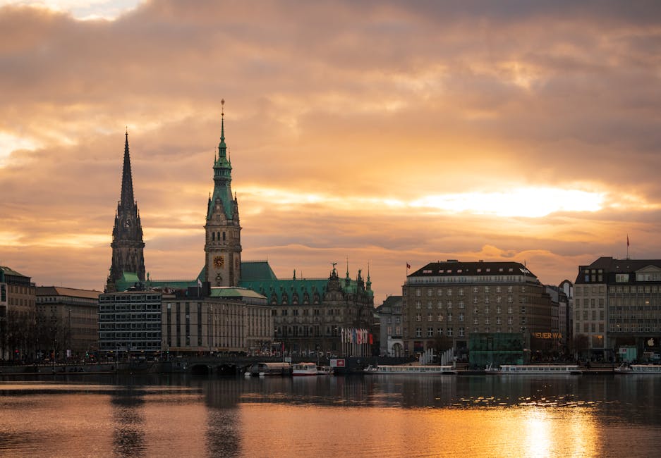 Stunning sunset over Hamburg skyline featuring historic architecture and waterfront reflections.