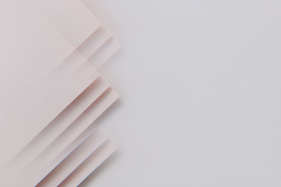 A minimalistic abstract composition featuring layered sheets on a gray surface, perfect for modern design.