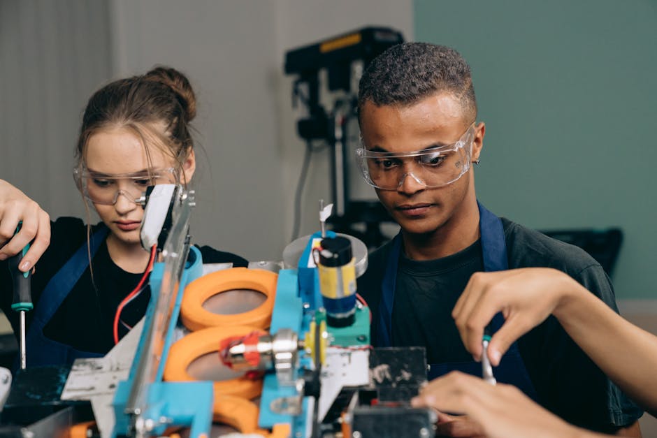Two young engineers focusing on a robotics project indoors, showcasing teamwork and technology.