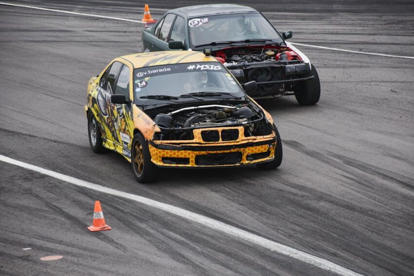 Dynamic shot of modified cars racing on a track, showcasing vibrant designs and speed.