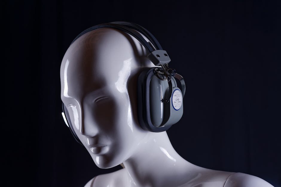 A minimalist image of a white mannequin wearing headphones, set against a dark background.