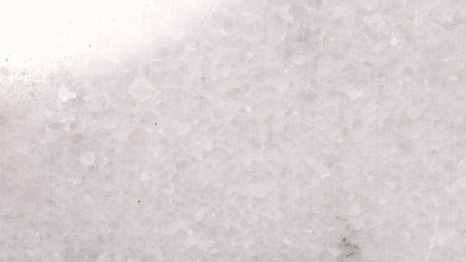 A detailed close-up of white marble surface showcasing texture and patterns.